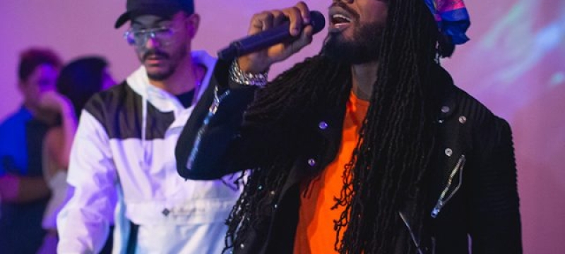 Silent Addy performs at DJ booth while Gyptian sings in front of him