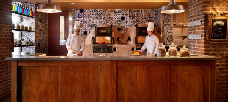 two chefs cook in kitchen