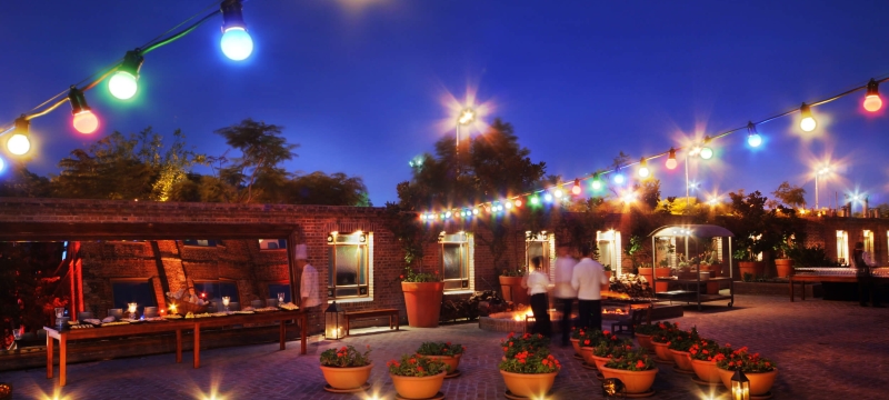 patio lit up by multicolored strings of lights