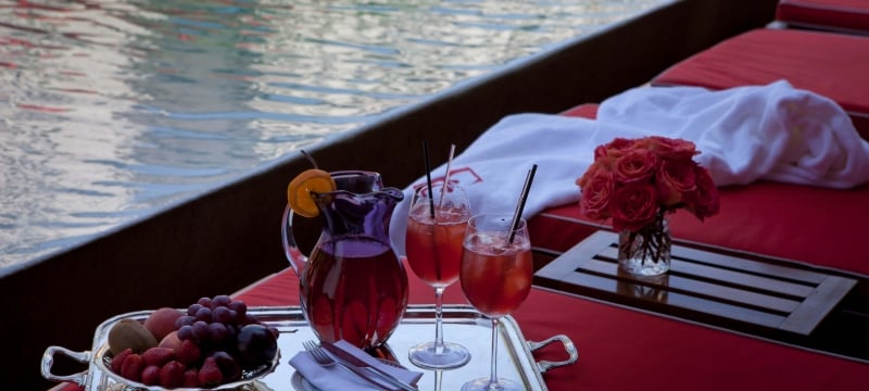 tray of fruit and cocktails poolside