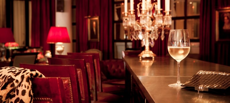 library lounge seats at the bar with wine glass and candlestick