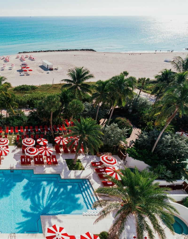 Aerial view of hotel pool on the edge of beach