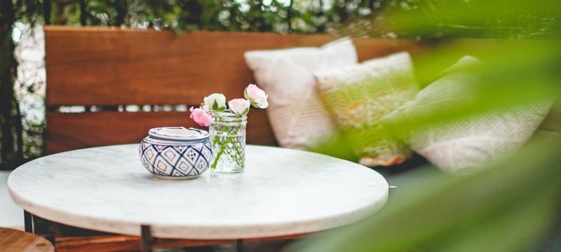 private seating area on patio surrounded by greenery