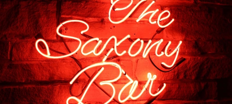 neon sign of The Saxony Bar