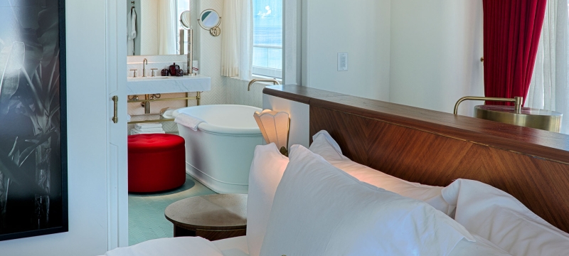 bed with bathroom in the background