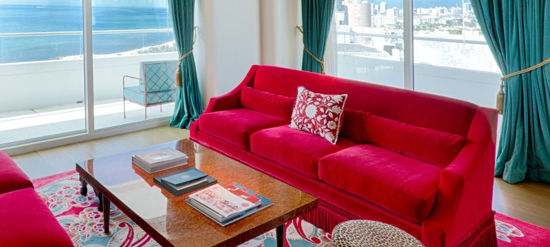 living room in imperial suite with red couch