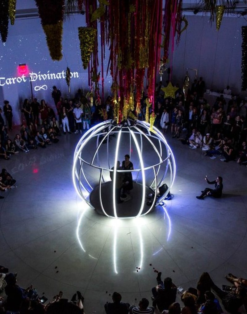 Jen DeNike performs in white sphere