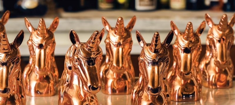 Gold unicorn figurines on table