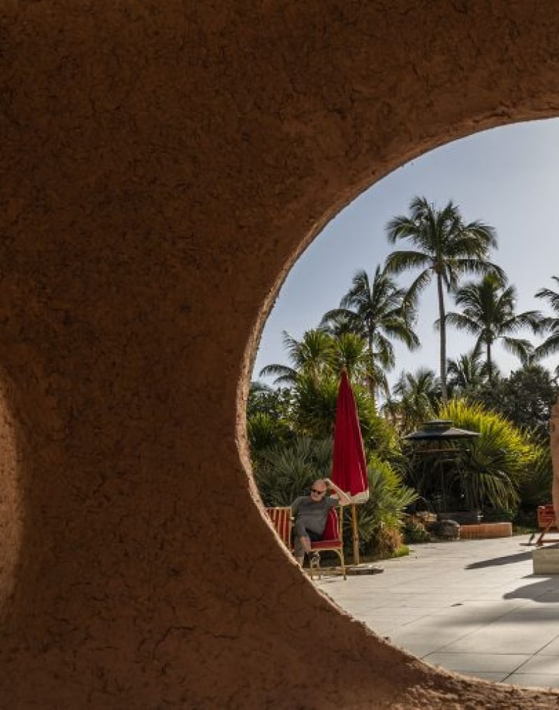 various statues are viewed through holes in wall