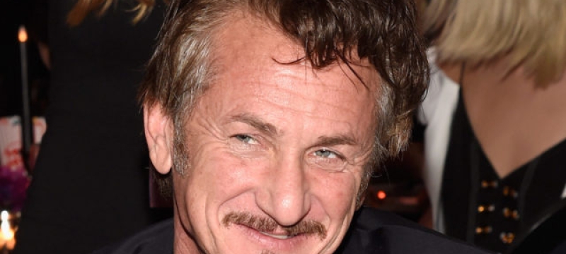 close up of Sean Penn smiling wearing a black shirt