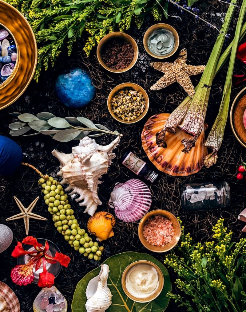 flat lay of starfish, shells, gems, and trinkets