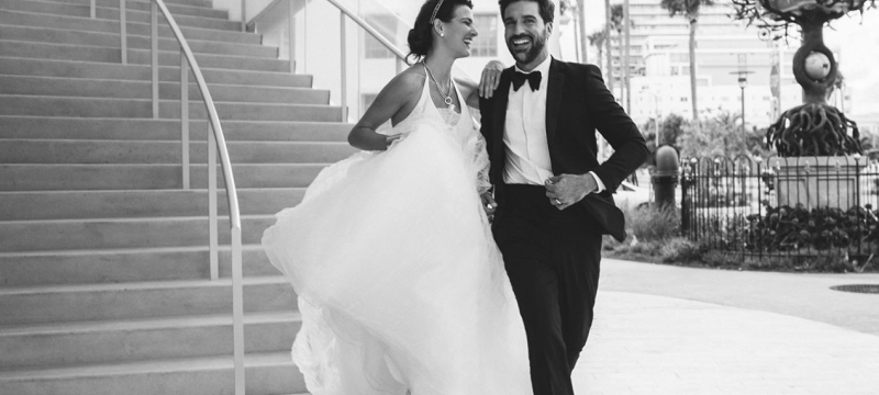 Bride and groom running down stairs