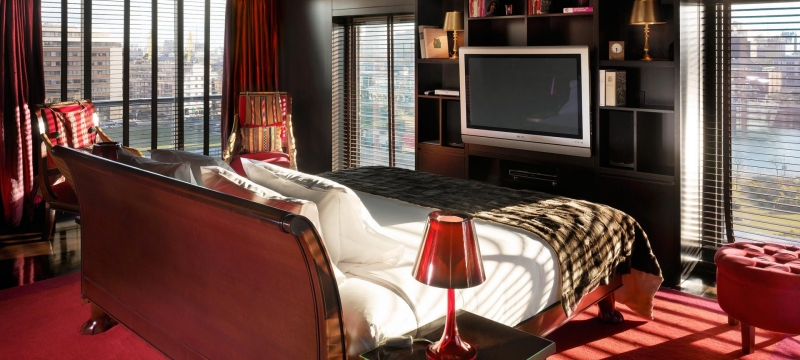 bedroom in the middle of a room facing a television