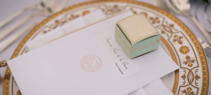 plate setting with wedding menu and gift box