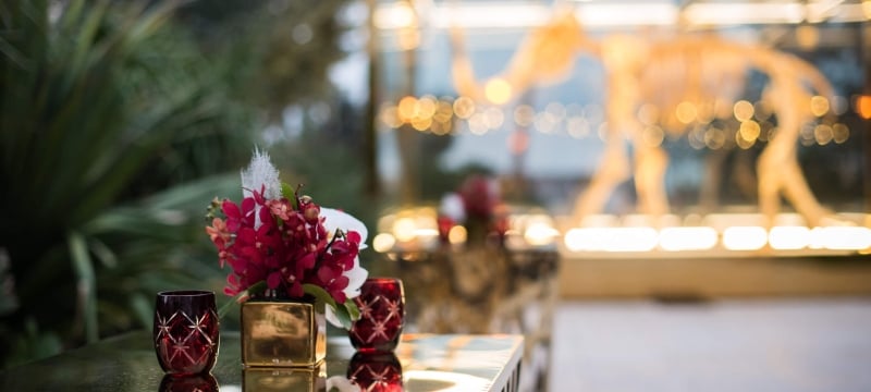 wedding flower centerpiece on a table with two glasses