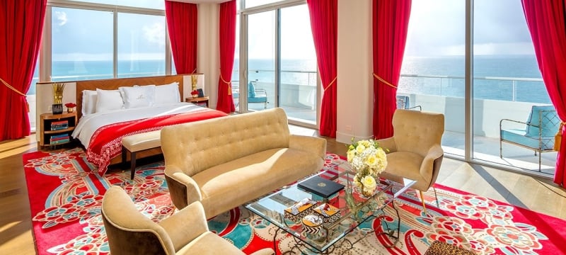 hotel bedroom with sitting area containing couch and two chairs