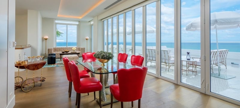 dining area in hotel penthouse with a wall of windows