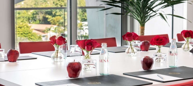 Meeting room in the Faena Forum with a  boardroom table set up 