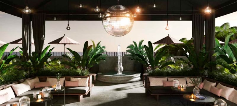 outdoor seating area with disco ball and tropical plants