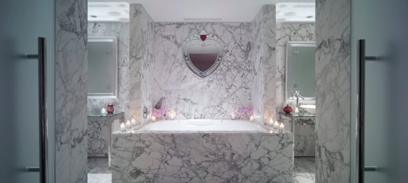 large marble bathtub in hotel suite
