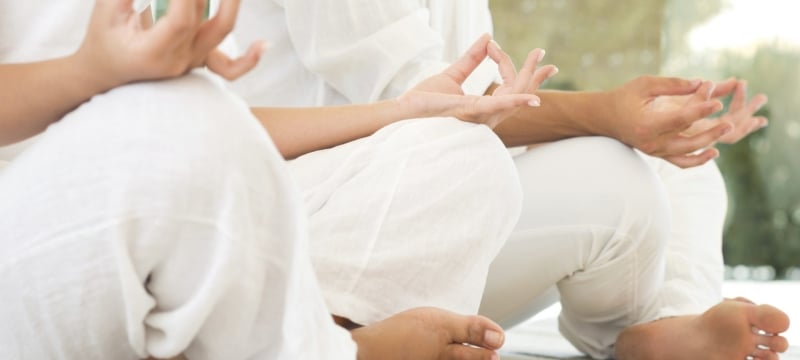 two people sitting in lotus position