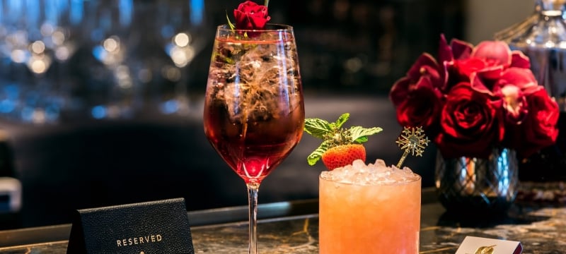 two cocktails on a bar