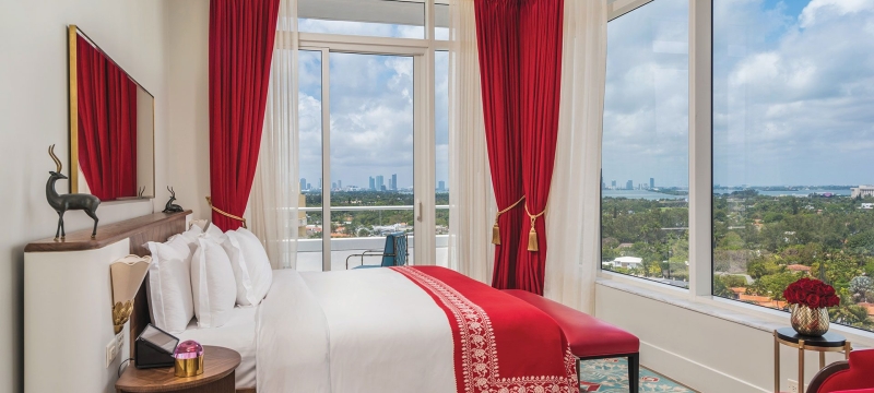 bedroom in hotel with large windows on two sides