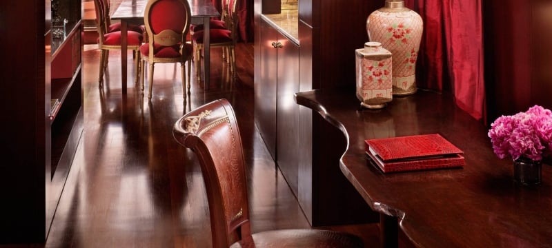 wooden desk and chair with dining table in the background