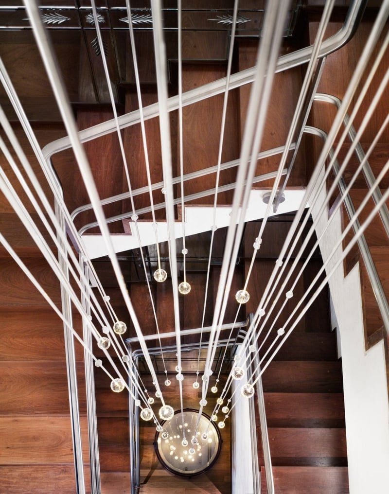 looking down a staircase with hanging lightbulbs