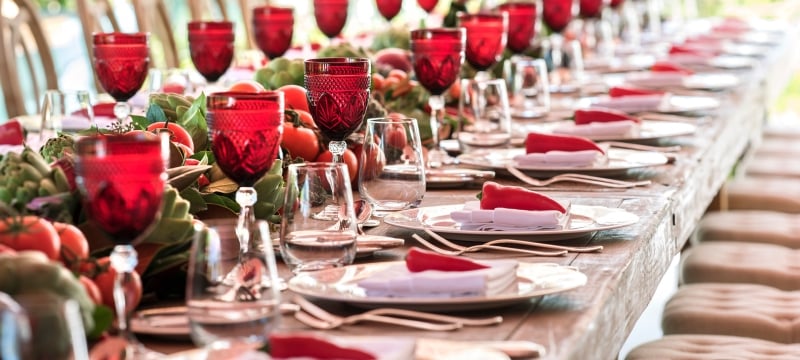 long table with place settings and wine glasses