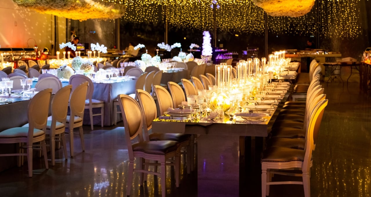 a long table with chairs and candles